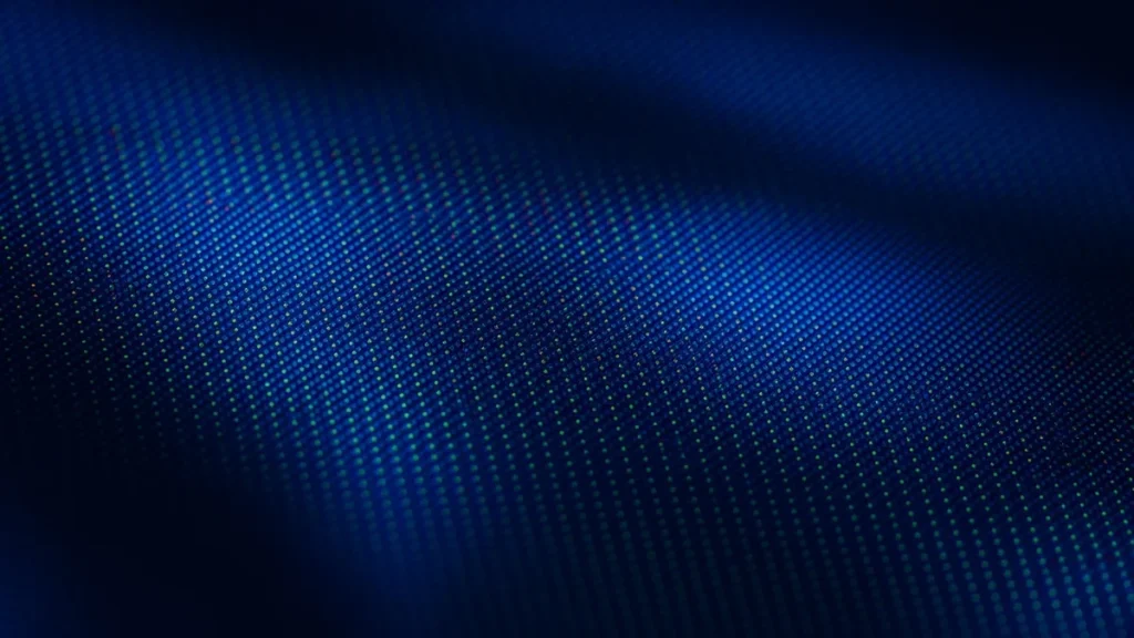Macro close-up of a 4K TV panel pixel grid glowing in deep blue